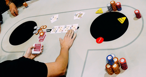 Close up of Texas Hold `em Tournament game where two players are all in AK vs QQ